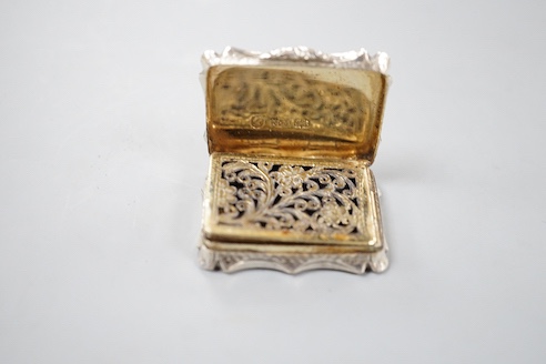 An early Victorian engine turned silver shaped rectangular vinaigrette, by Nathaniel Mills, Birmingham, 1843, 36mm, in leather box.